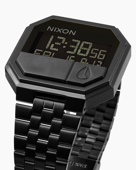 Black Nixon digital watch with metal strap on a white background