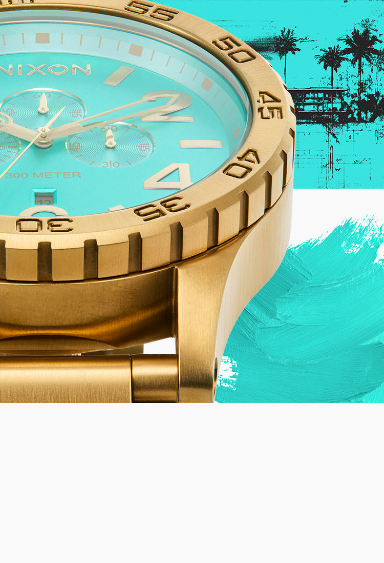 Gold Nixon watch with turquoise face on a colorful background